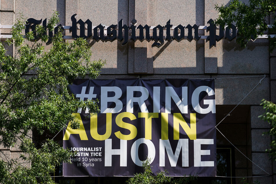 A #BringAustinHome banner, honoring freelance journalist Austin Tice who was abducted in Syria in 2012, hangs outside of The Washington Post headquarters in Washington DC.