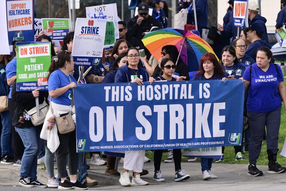 Nurses and health care professionals demonstrate during a strike against Kaiser Permanente outside one of their medical facilities in Los Angeles, California, on January 26, 2026.