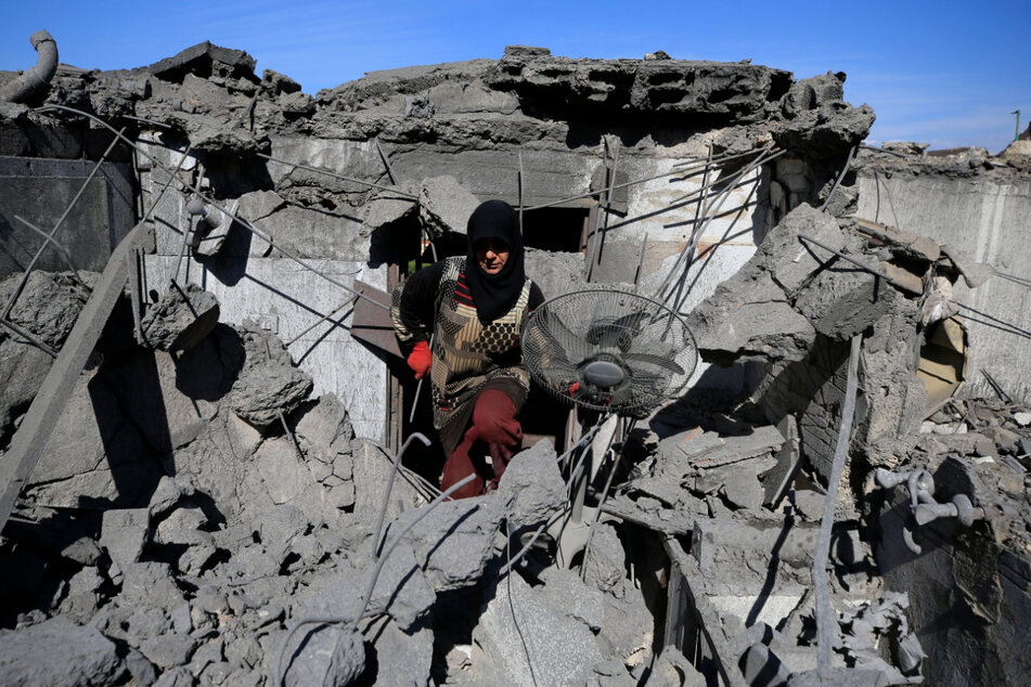 Eine Frau holt persönliche Gegenstände aus den Ruinen von Häusern, die durch israelische Luftangriffe zerstört wurden.
