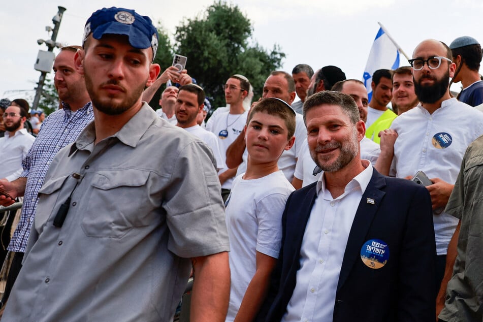 Finance Minister Bezalel Smotrich (front right) participates in a march as Israelis mark Jerusalem Day celebrating their conquest of Gaza and the West Bank on May 26, 2025.