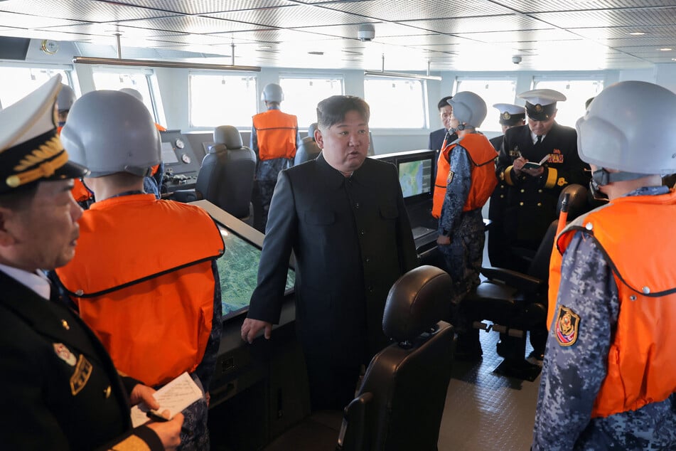North Korean leader Kim Jong Un was seen observing missile tests from a naval destroyer in photos shared by state media.