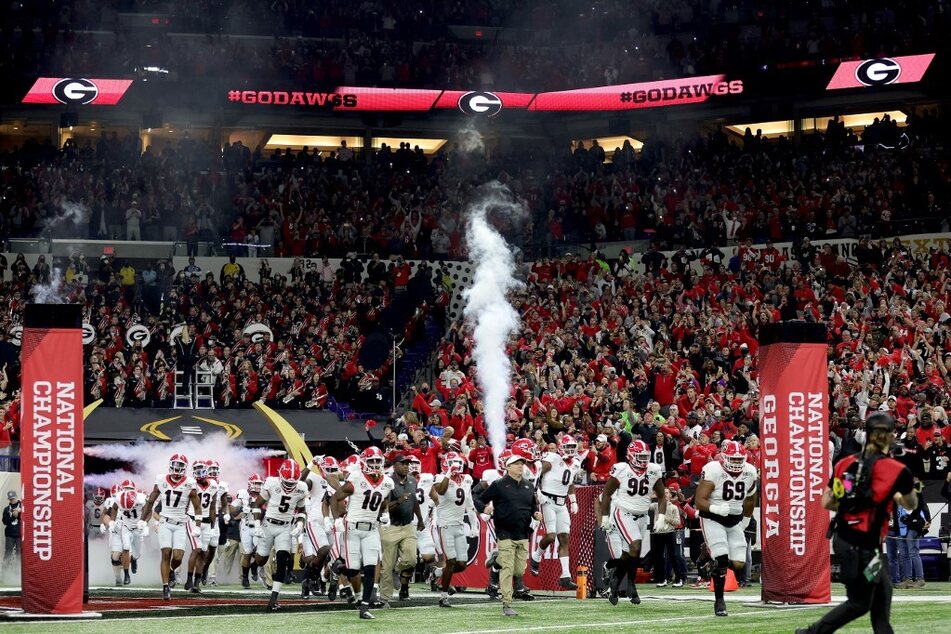 Georgia Bulldogs players, led by head coach Kirby Smart, entered the field before the 2022 CFP National Championship Game at Lucas Oil Stadium last season.