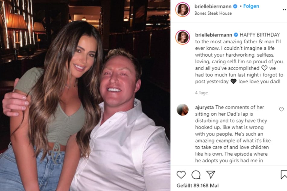 Instagram model Brielle Biermann sits on the lap of her (step-)father.