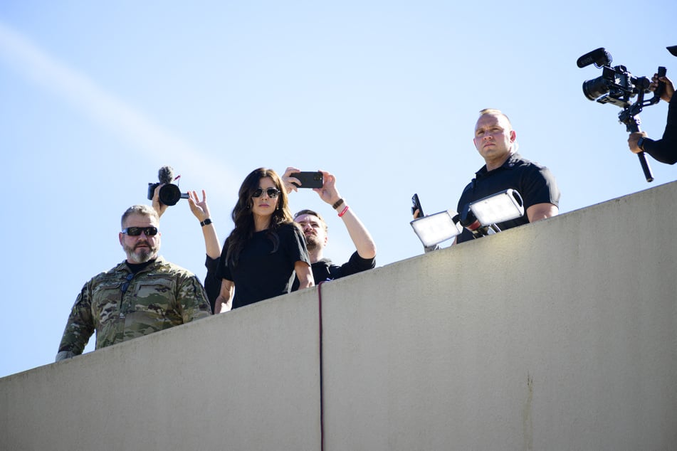 Homeland Security Secretary Kristi Noem (c.) was praised by MAGA after appearing to confront a man in a chicken suit.