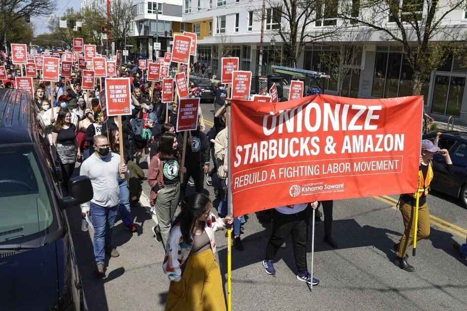 Starbucks workers and supporters march in Seattle's "Fight Starbucks' Union Busting" rally in April 2022.