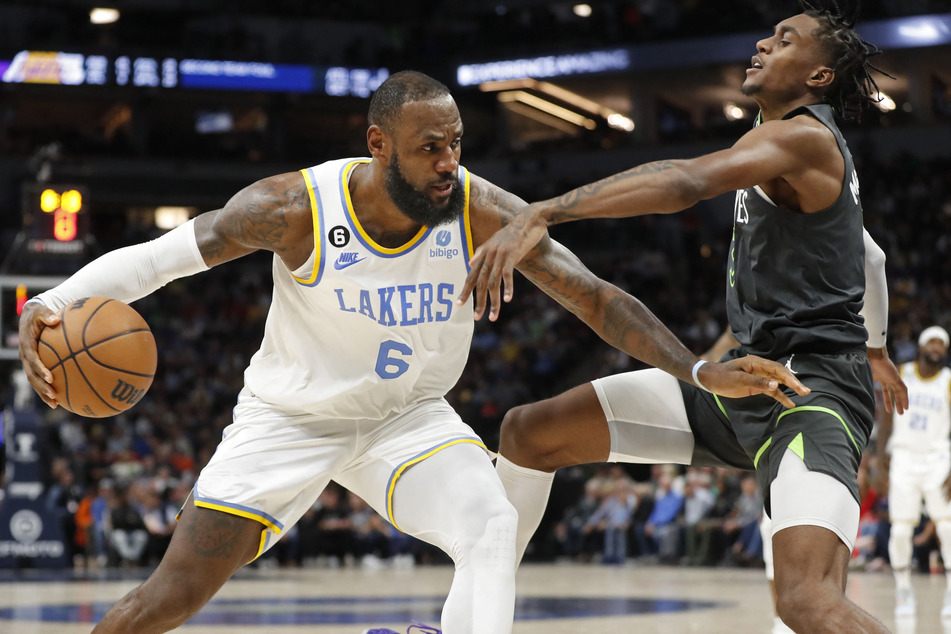 Los Angeles Lakers forward LeBron James works around Minnesota Timberwolves forward Jaden McDaniels in the fourth quarter at Target Center.