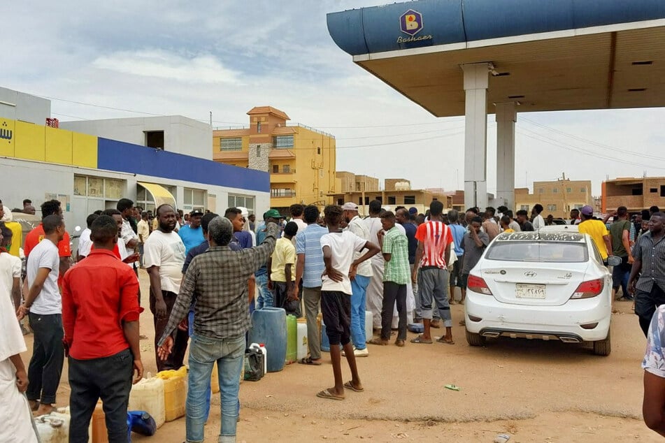 People in Khartoum gather to collect fuel as the humanitarian situation in Sudan deteriorates.
