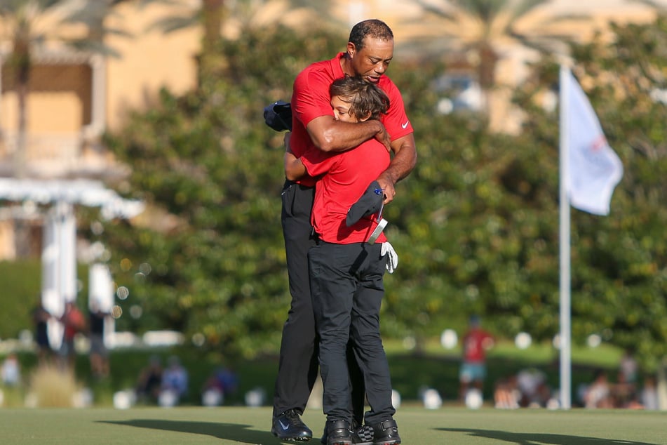 December 19, 2021, Orlando, Florida, USA: Tiger Woods embraces his son, Charlie Woods (r.) after the final round of the PNC Championship at the Ritz-Carlton Golf Club in Orlando, Florida.