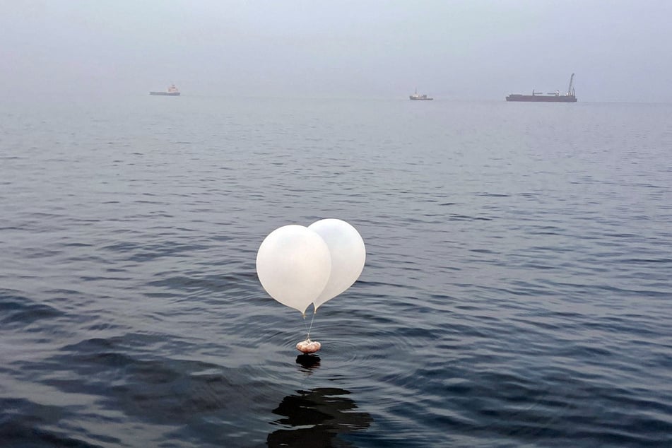 A balloon carrying various objects including what appeared to be trash, believed to have been sent by North Korea, is pictured at the sea off Incheon, South Korea.