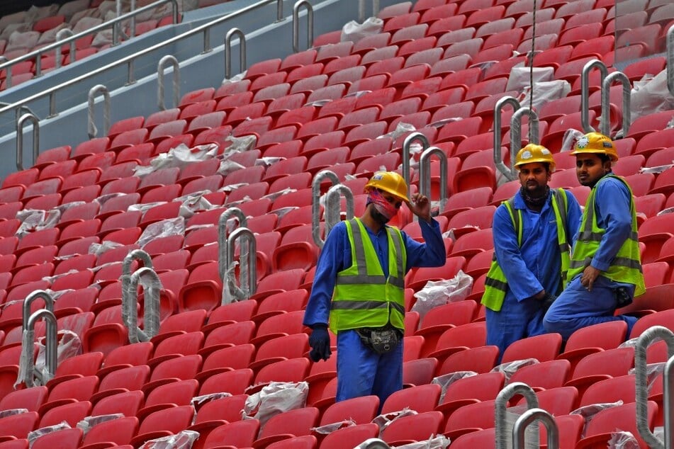 Construction workers work in the stands of Qatar's new al-Bayt Stadium in the capital Doha, which will host matches of the 2022 FIFA World Cup.