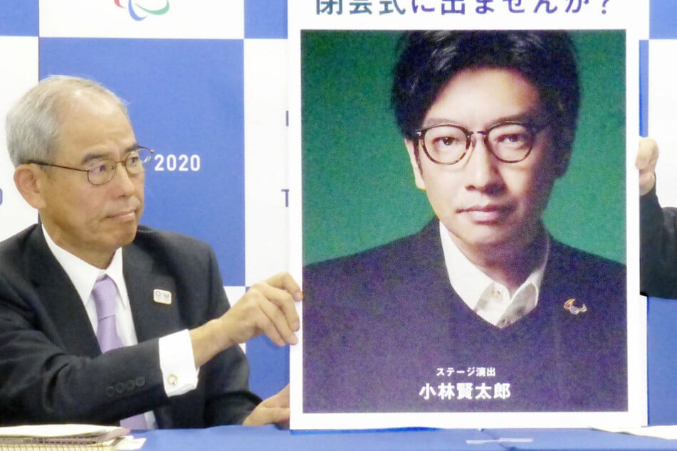 Kentaro Kobayashi, shown here in the photo being held up at a 2000 press conference, is a former comedian.