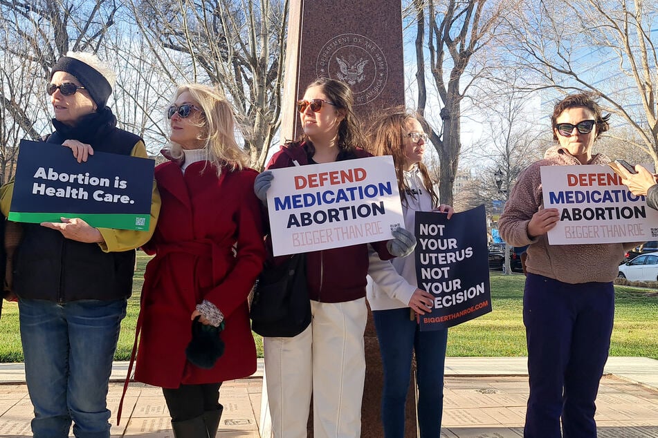 Abortion rights advocates hold signs reading "Defend Medication Abortion" outside the J. Marvin Jones Federal Building and Courthouse in Amarillo, Texas, on March 15, 2023.