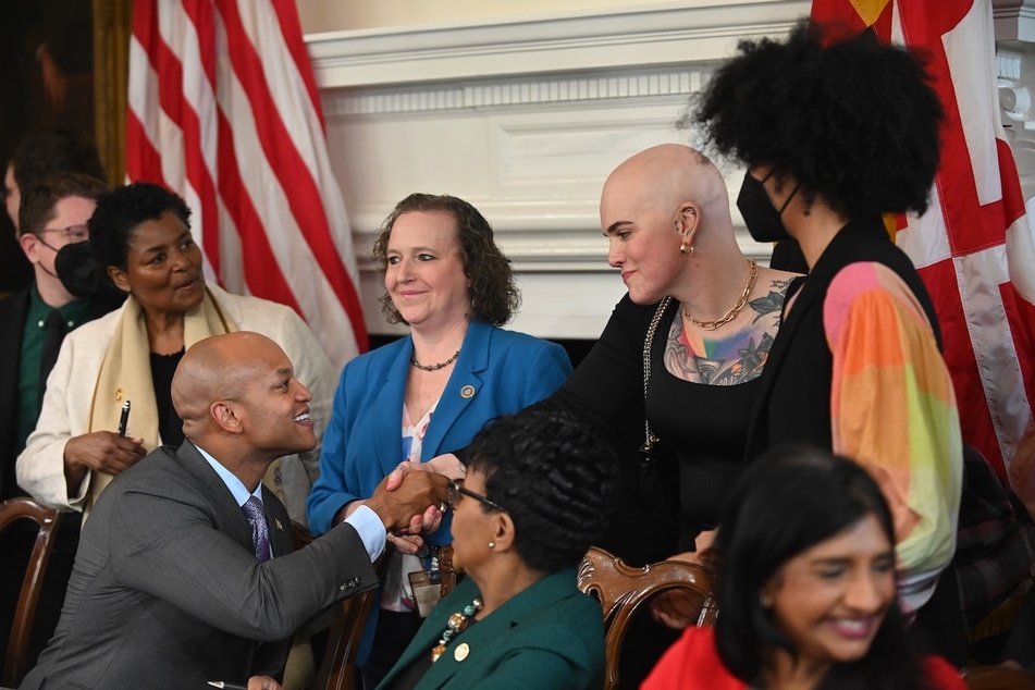 Wes Moore shakes hands with Marylanders during the bill signing ceremony.