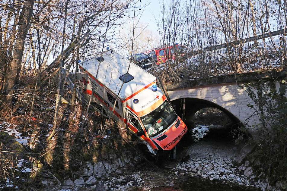 After the accident, the ambulance nearly fell down a slope and lands in the creek.