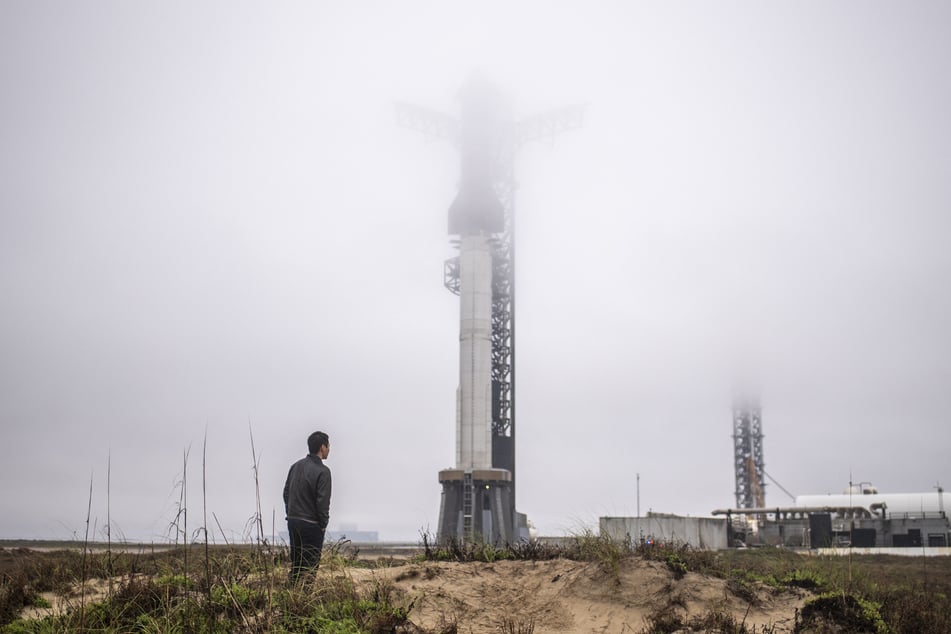 A visitor looks at the launch site of the SpaceX Starship rocket during inclement weather on Tuesday, near Boca Chica, Texas.