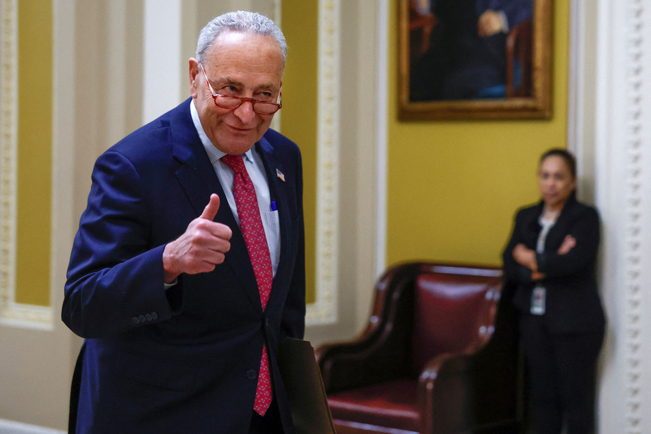 Democratic Senate Majority Leader Chuck Schumer gives the thumbs up as the Senate votes to suspend the federal debt limit.