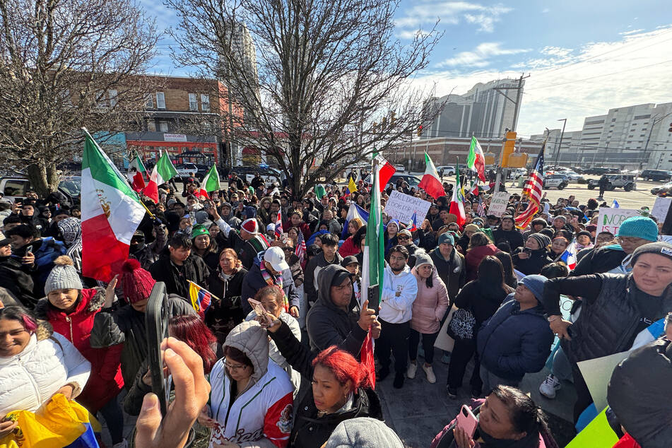 People hold flags from different countries as they gather at a demonstration in support of immigrants' rights in Atlantic City, New Jersey, on February 3, 2025.