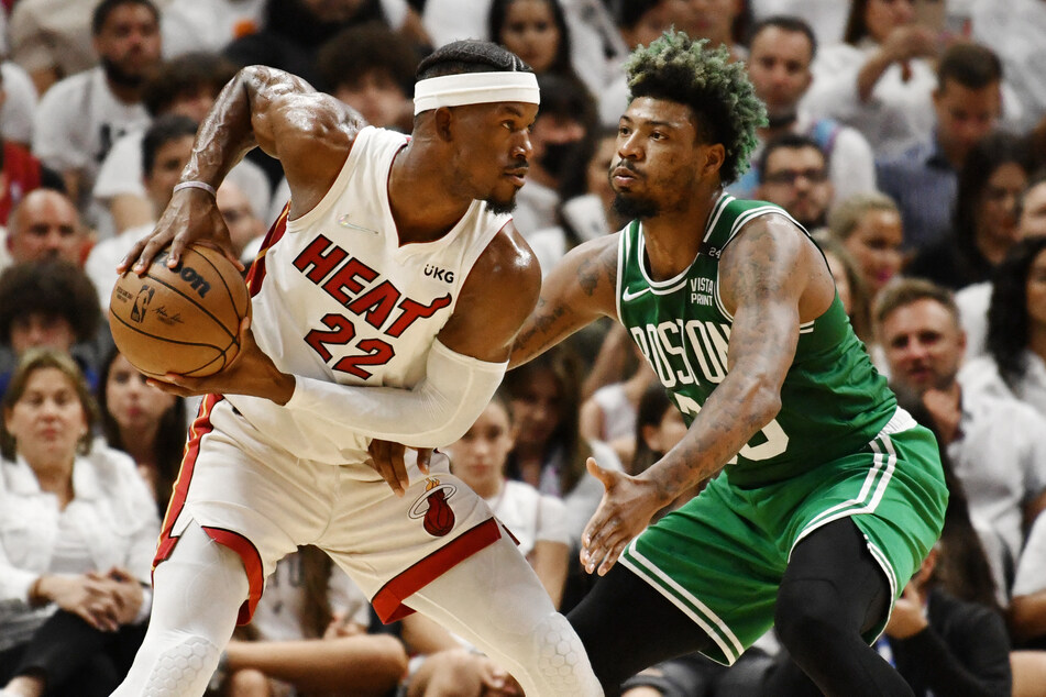 Defensive Player of the Year Marcus Smart (r.) guarding the Heat's Jimmy Butler, who scored 29 points.