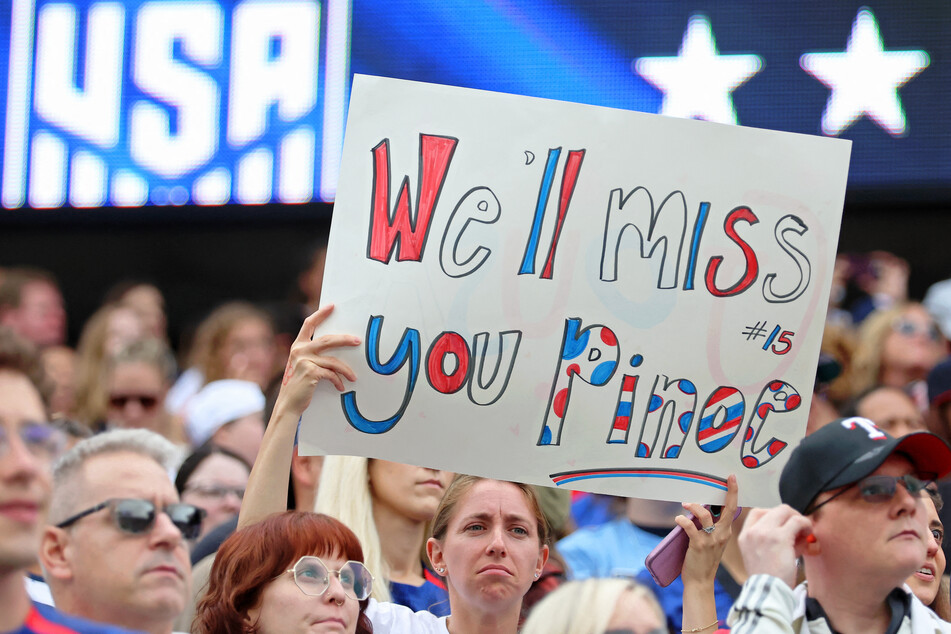 Fans hold up signs in support of Megan Rapinoe before the game between the United States and South Africa at Soldier Field.