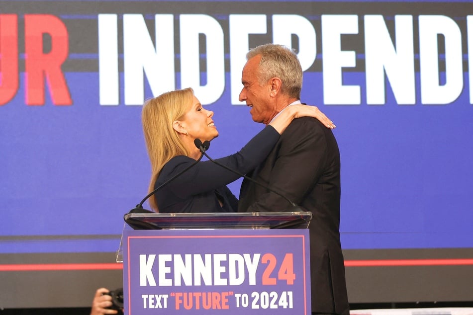 Cheryl Hines (l.) embracing her husband Robert F. Kennedy Jr. during a campaign event at the Henry J. Kaiser Event Center in Oakland, California on March 26, 2024.