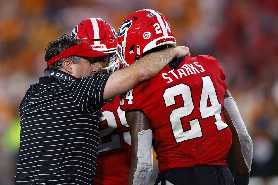 Georgia head coach Kirby Smart (l) updated fans on the status of two marquee Bulldog players, Ladd McConkey and Warren McClendon, who have been missing practices due to injury.