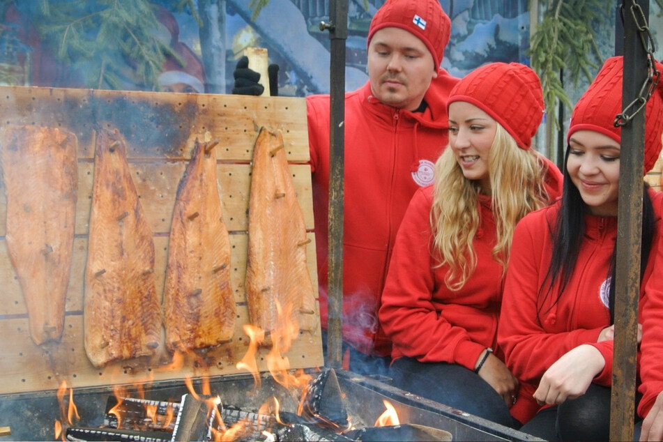 Im Finnischen Weihnachtsdorf wird der Lachs am offenen Feuer gegart.