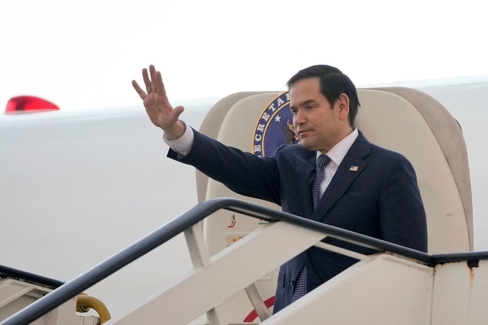 Secretary of State Marco Rubio waves before his departure at Las Americas International Airport in Santo Domingo, Dominican Republic, on February 6, 2025.