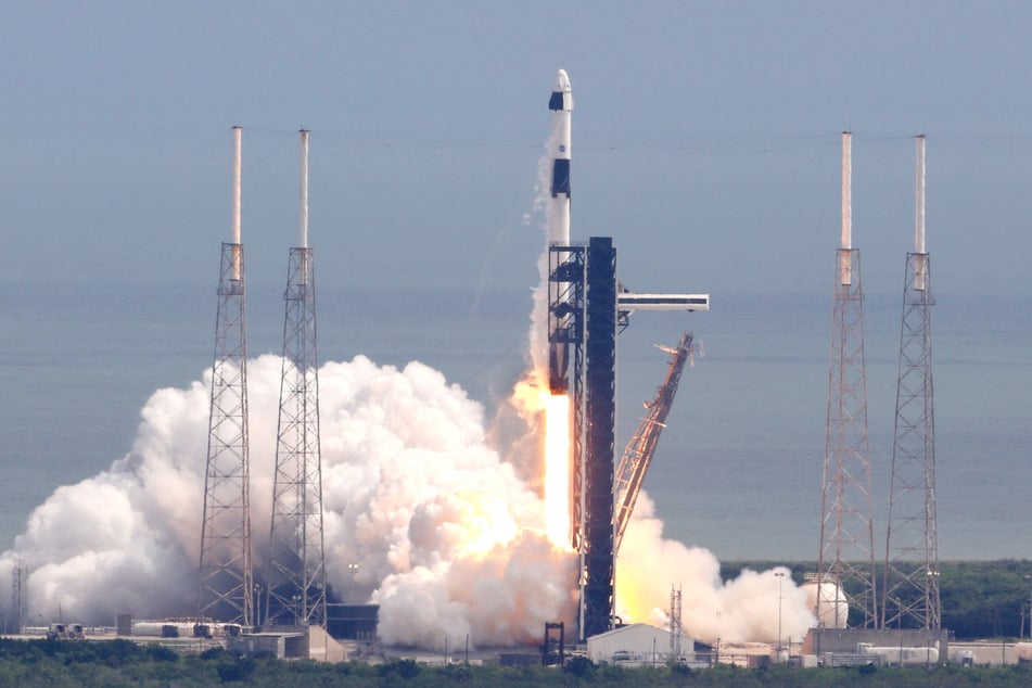 A SpaceX rocket soared into the sky Saturday with two passengers on board, leaving two seats empty to return American astronauts who have been stranded for months on the International Space Station, NASA said.