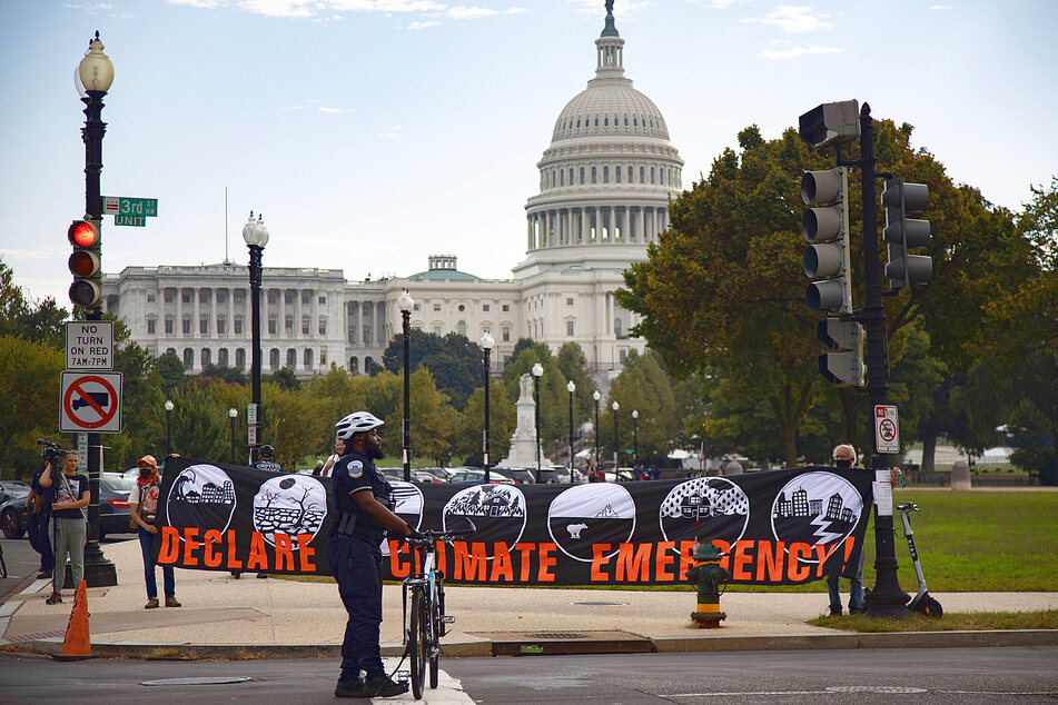 Environmental activists march to the US Capitol on October 15 on the last day of a week of protest actions to bring attention to climate change.