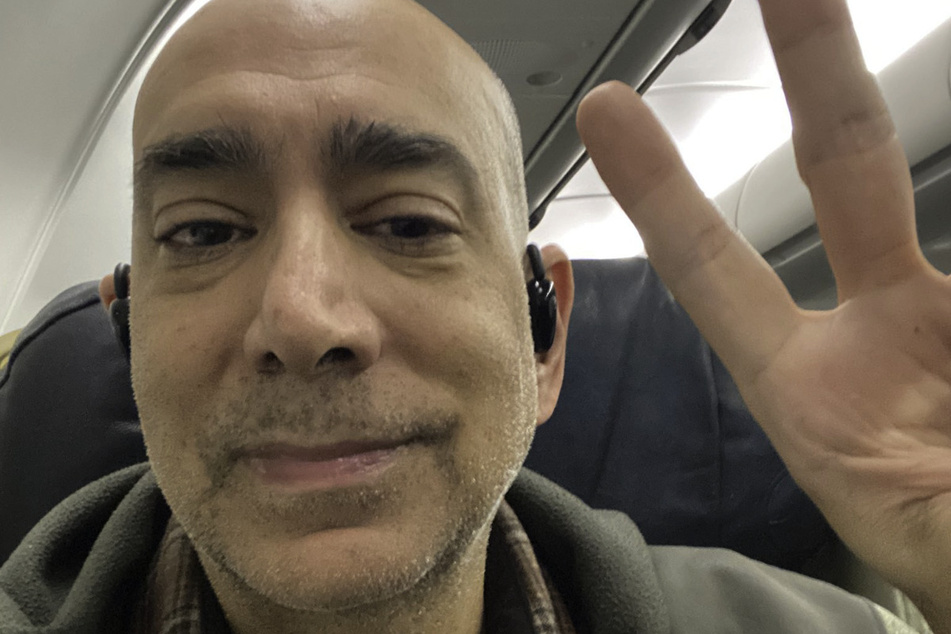 Palestinian-American journalist Ali Abunimah shares a selfie taken on a plane after his release from Swiss custody.