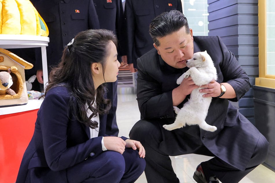 Kim Jong-un cuddles puppies and kittens on outing to North Korean pet shop