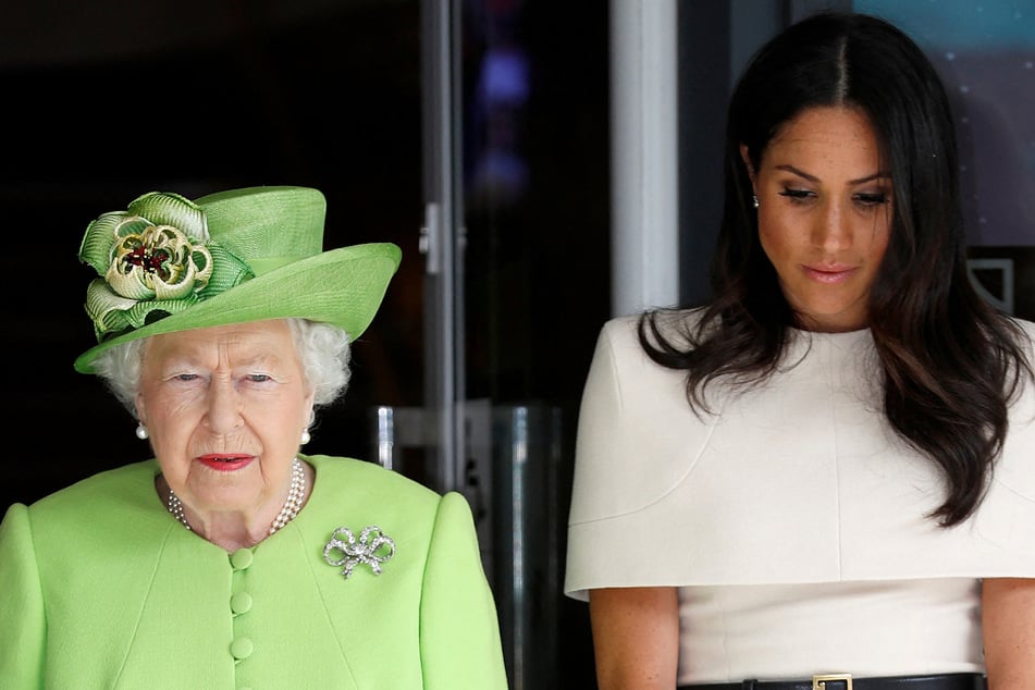 The late Queen Elizabeth II (l.) is said to have conducted a survey of palace staff members after allegations emerged that Meghan Markle had fostered a "hostile" environment for employees.