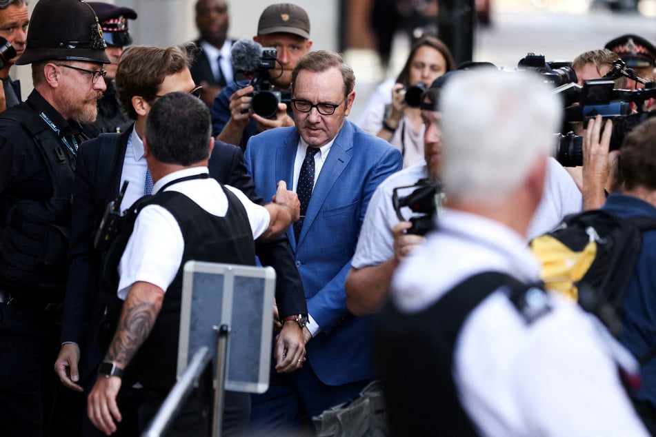 Reporters surround Spacey as he enters the Central Criminal Court.