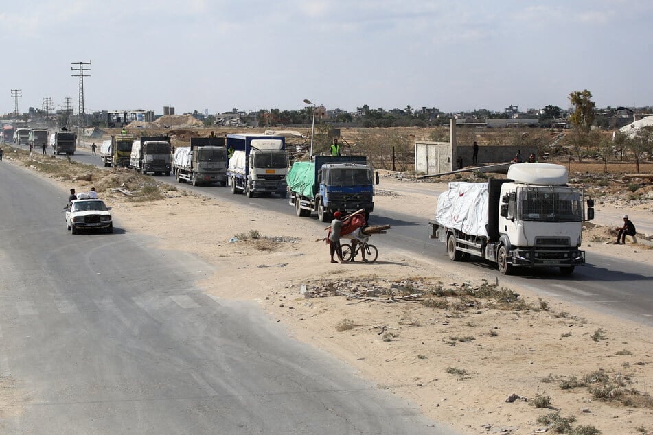 Trucks carrying aid provided by the World Food Programme drive on a road in Deir el-Balah after entering through the Kerem Shalom crossing in the southern Gaza Strip on October 17, 2025.