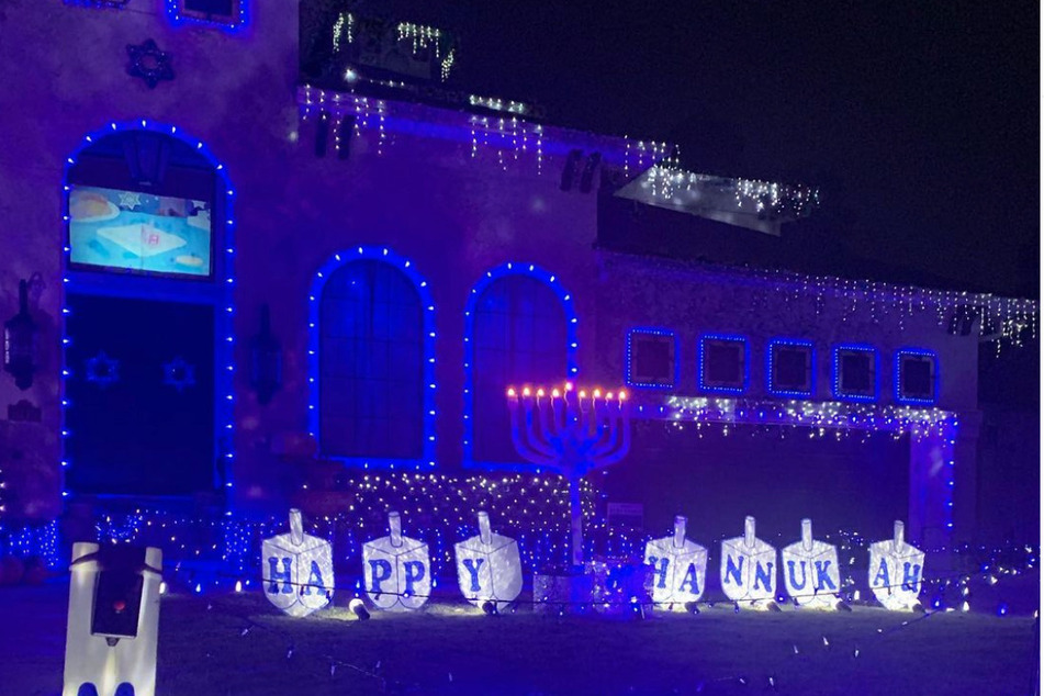 Philip's yard and house is covered with lights for Hanuukkah.