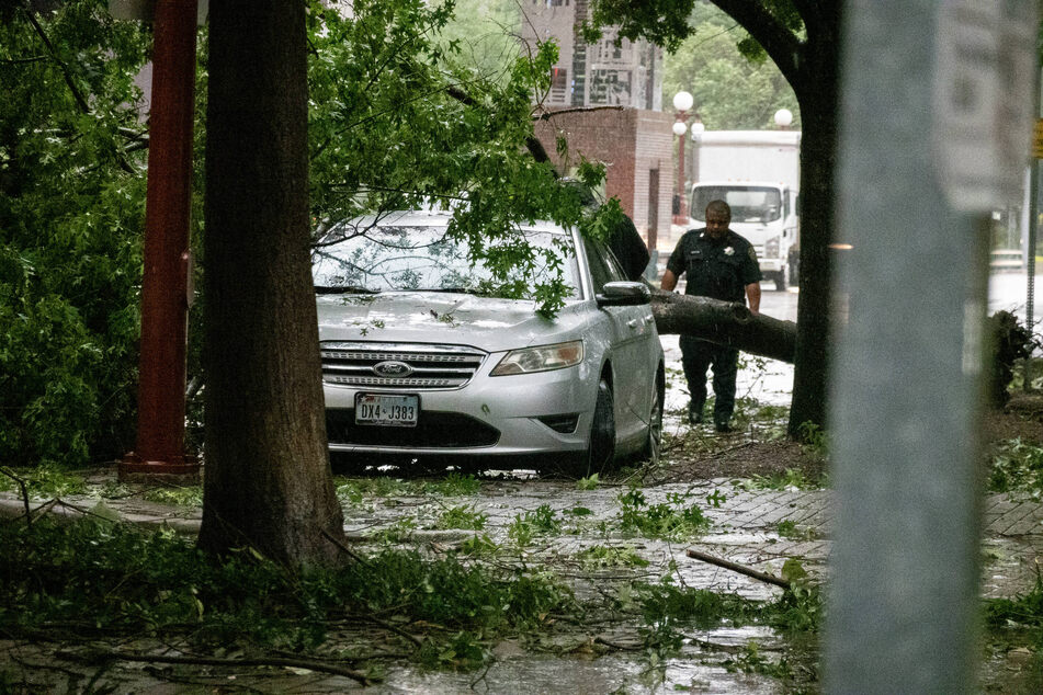 A car damaged by a storm is pictured in downtown Houston, Texas, following strong rains and winds that left at least four people dead.