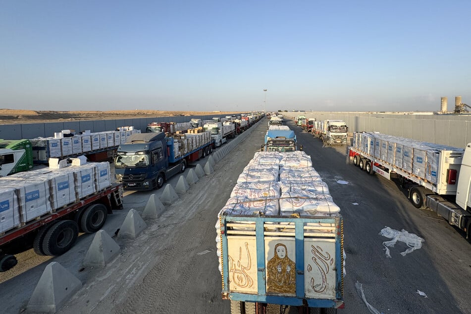 Trucks loaded with humanitarian aid await permission on the Egyptian side of the Rafah crossing with the Gaza Strip to drive toward the besieged Palestinian territory on August 3, 2025.