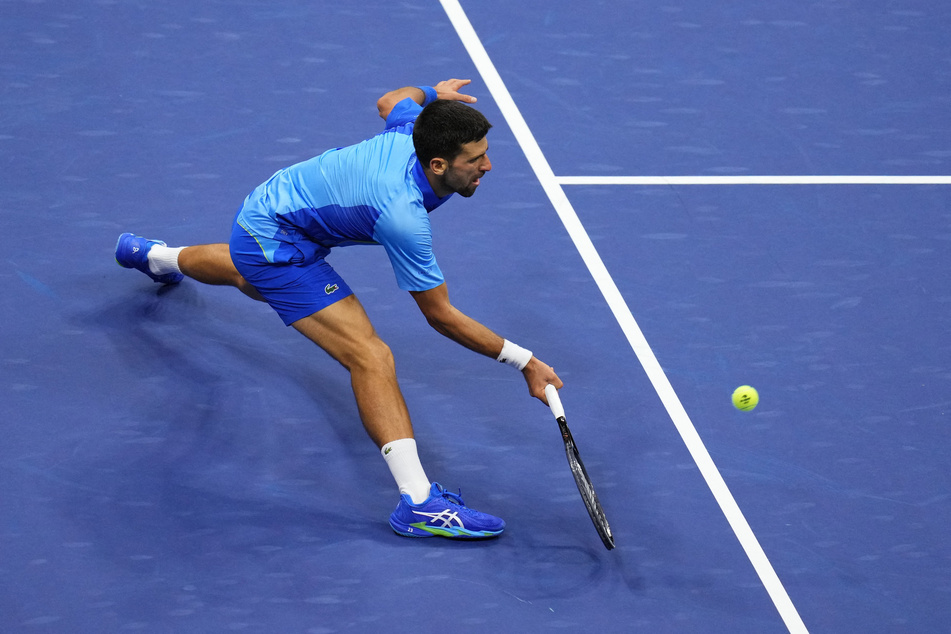 Novak Djokovic reaches for a forehand against Daniil Medvedev in the men's singles final of the 2023 US Open.