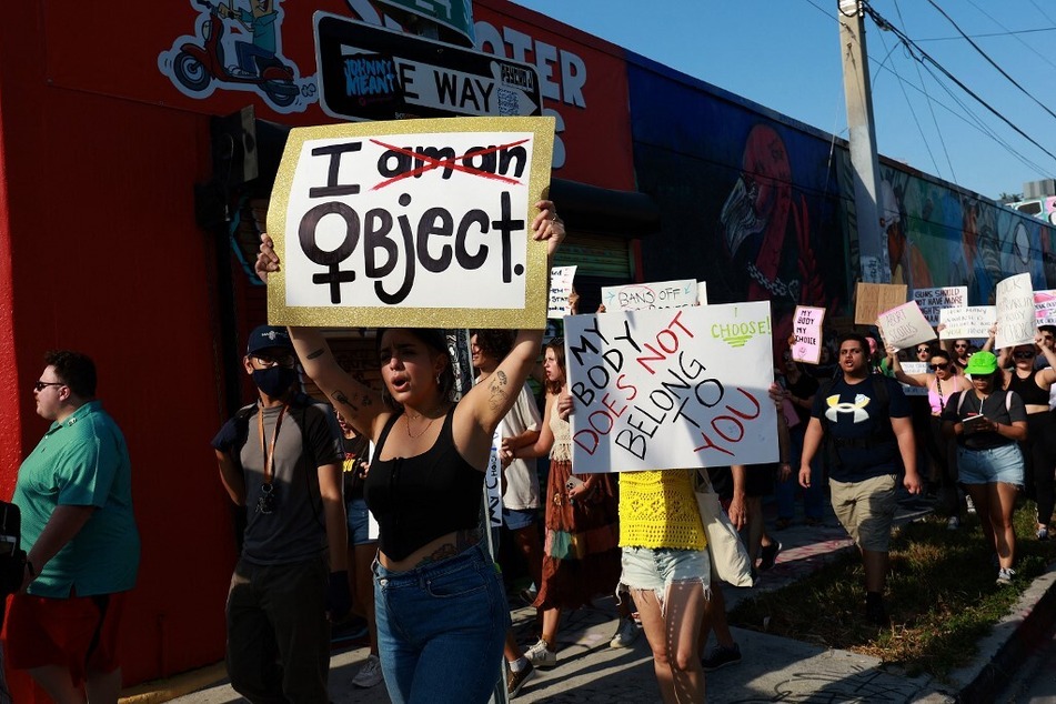 People march together to protest the US Supreme Court's decision in the Dobbs v. Jackson Women's Health case, on June 24, 2022, in Miami, Florida.