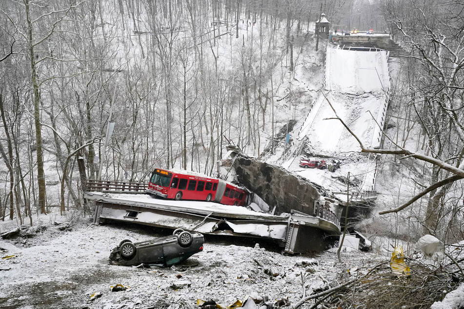 Ein Bus und zwei Autos befinden sich noch auf oder an der eingestürzten Brücke.