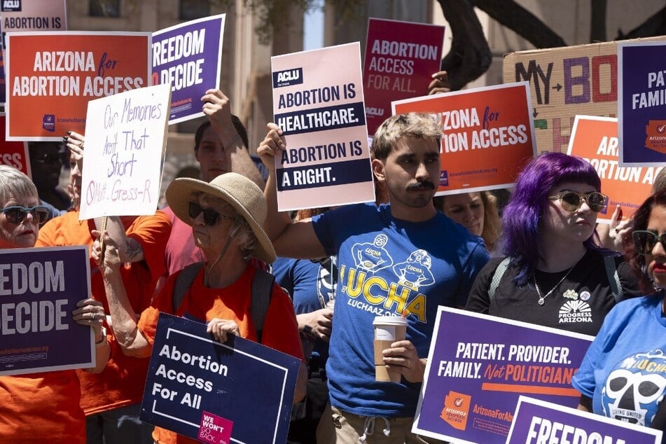 Members of Arizona for Abortion Access, the ballot initiative to enshrine abortion rights in the state constitution, hold a rally in Phoenix.