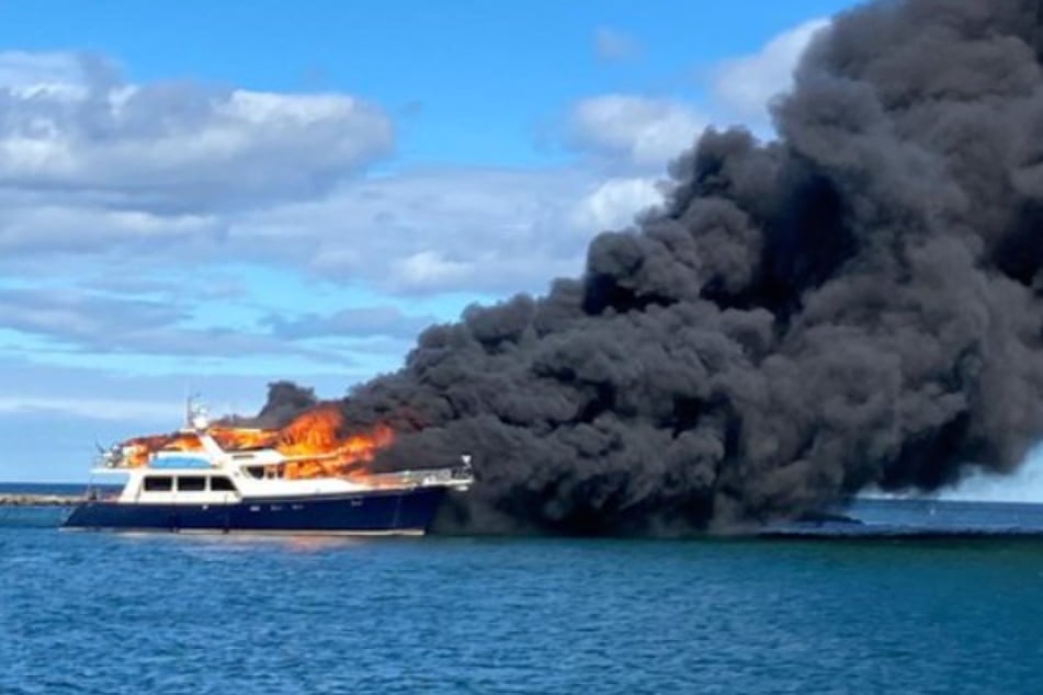 It was a stark scene as the luxury yacht burned and billowed with black smoke.