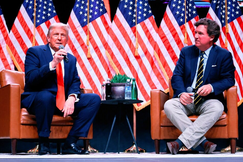 Donald Trump (l.) sits down for a conversation with Tucker Carlson during his Live Tour at the Desert Diamond Arena in Phoenix, Arizona on October 31, 2024.