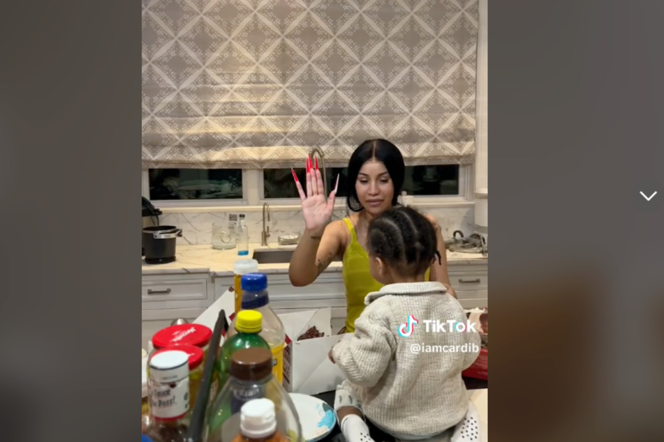 Cardi B gives her son Wave a high five in her "regular day" TikTok.
