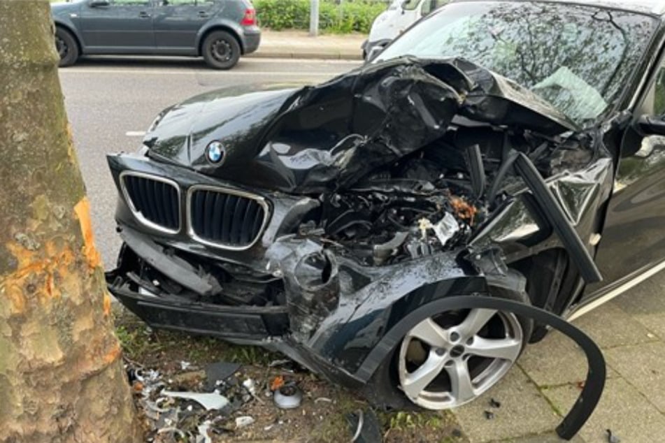 Der BMW krachte frontal gegen einen Baum und blieb dort stark beschädigt stehen.