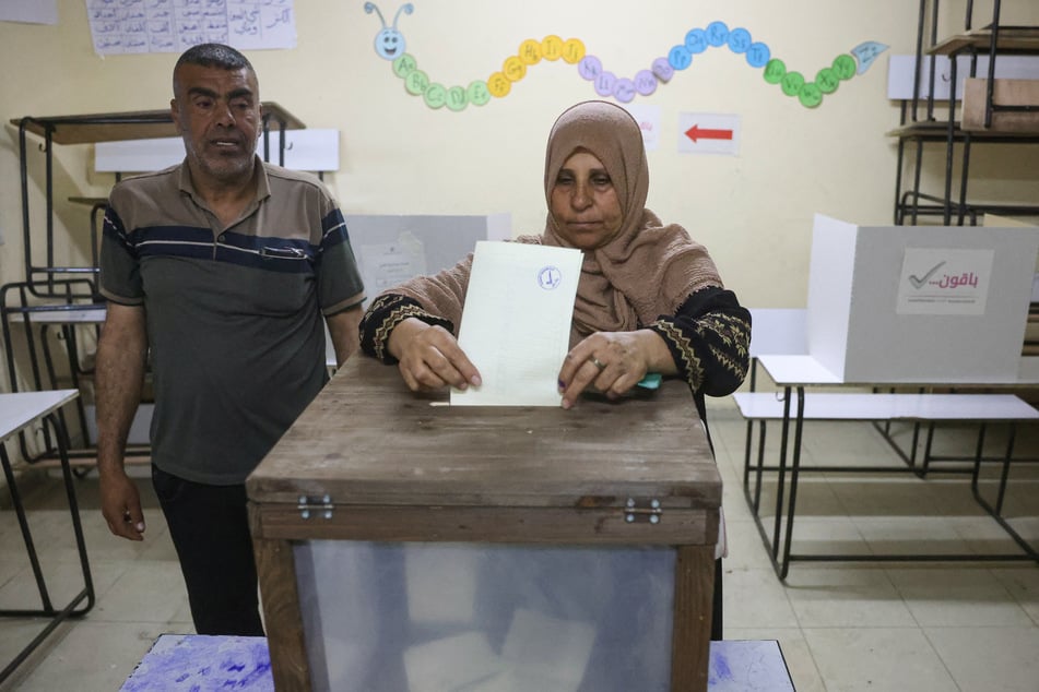 A Palestinian woman casts her ballot at a polling station during municipal elections in Deir el-Balah, in the central Gaza Strip, on April 25, 2026.