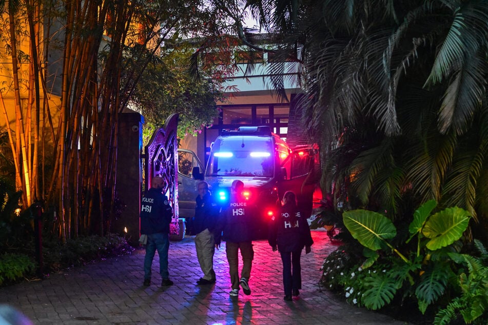 Homeland Security Investigation agents are seen at the entrance of producer and musician Sean "Diddy" Combs's home at Star Island in Miami Beach on March 25, 2024.