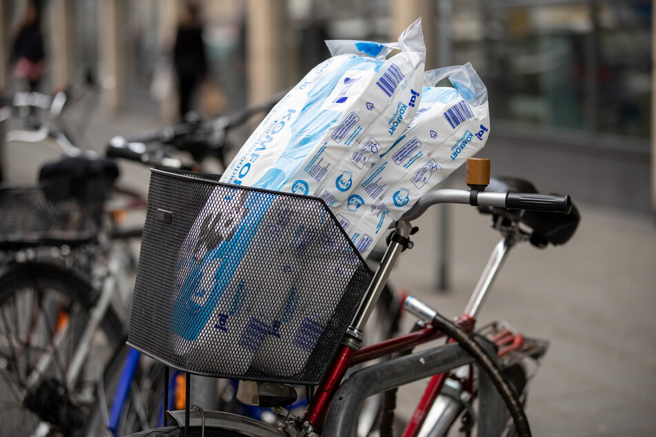 Zwei Packungen Toilettenpapier stecken in einem Fahrradkorb. Zu Beginn der Corona-Krise kam es bei Toilettenpapier zu Hamsterkäufen.