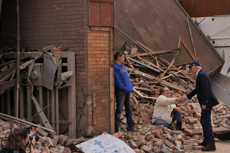 Joe Biden shaking hands with a local from Mayfield, Kentucky, a town ravaged by the tornadoes that hit multiple states last weekend.