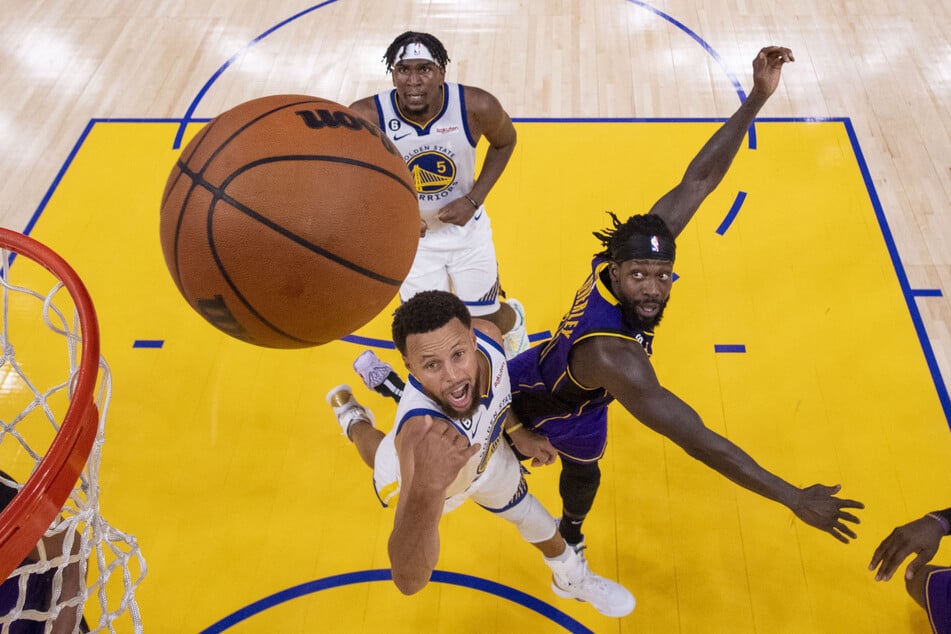 Golden State Warriors guard Stephen Curry shoots the basketball against Los Angeles Lakers guard Patrick Beverley during the second half at Chase Center.